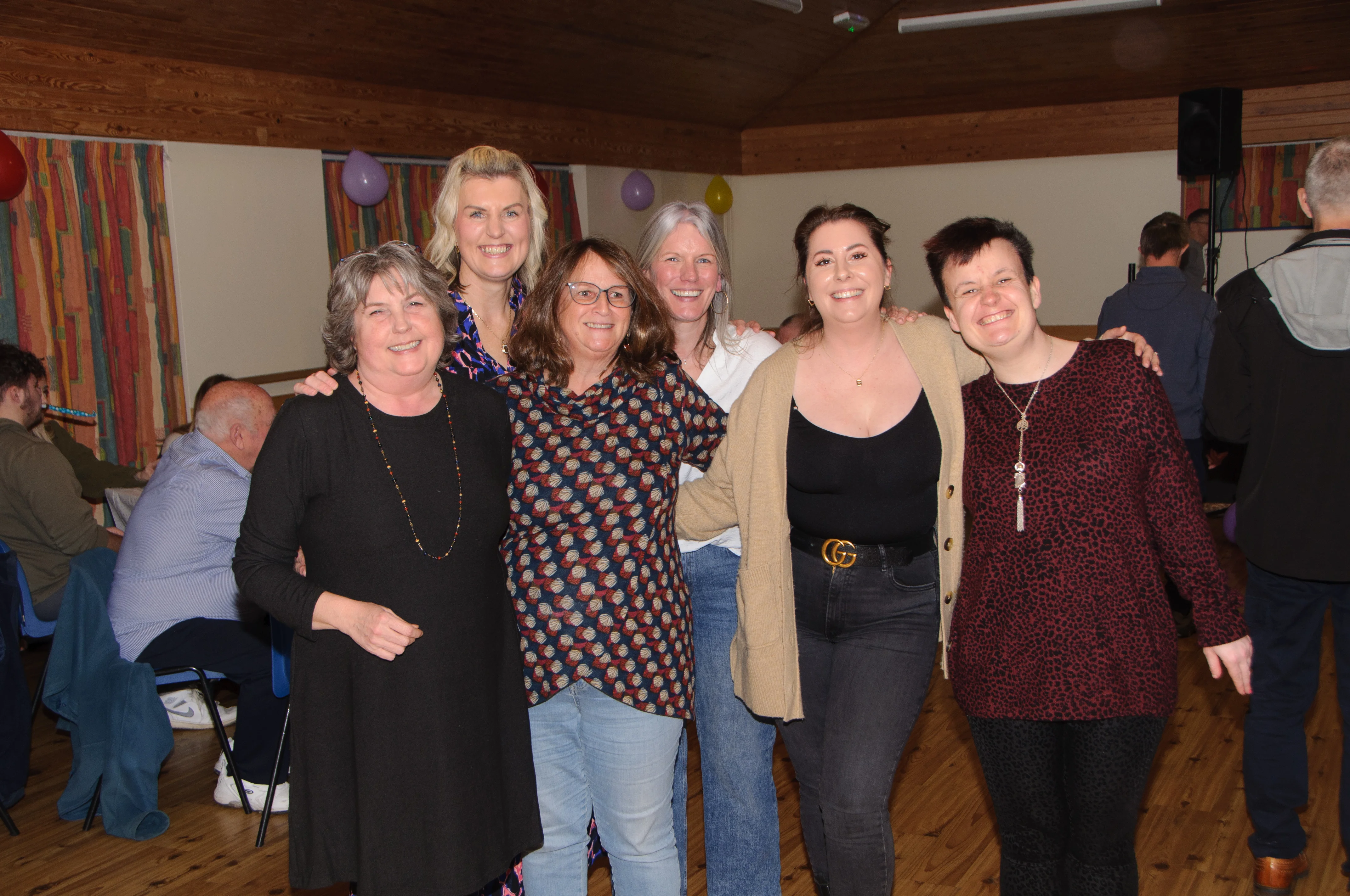 Members of the Shared Lives team with a supported person at a party