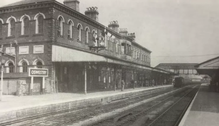Black And White Photo Of The Outside Of The Railway Station