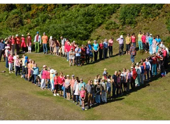 Group of people making a heart outline